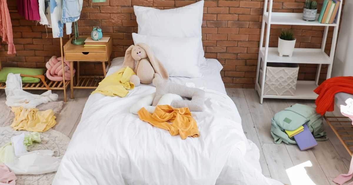 making bed in messy bedroom