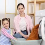parent and child doing household chores together at home
