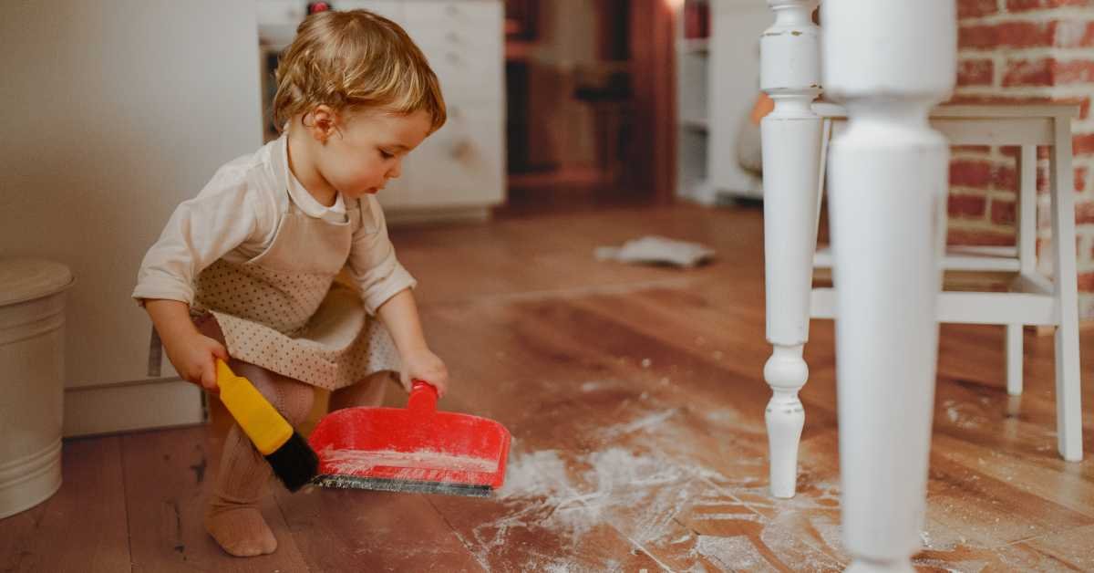 toddler helping with cleaning at home
