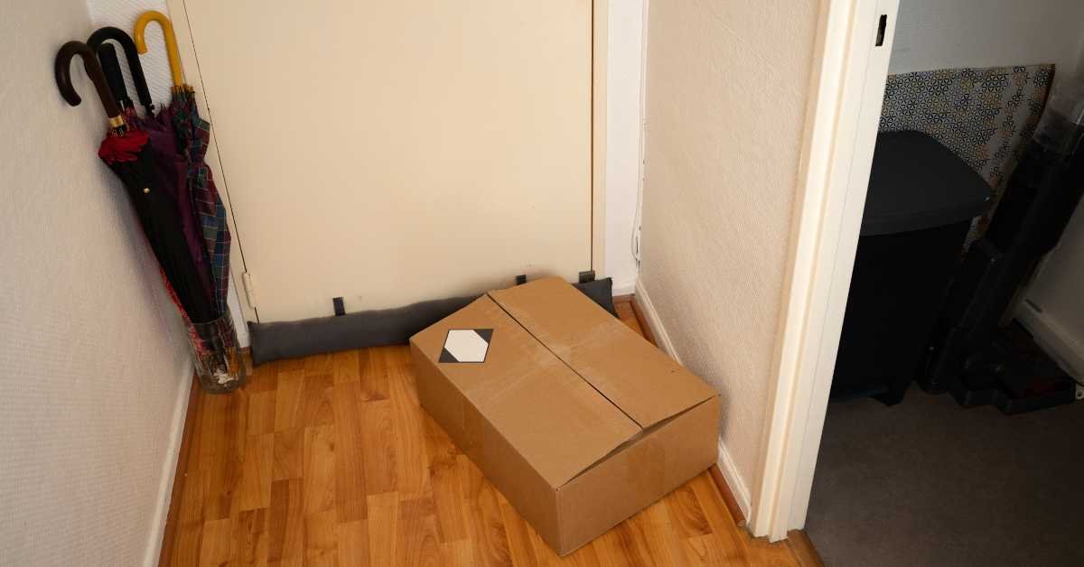 open cardboard box on floor after delivery everyday home clutter