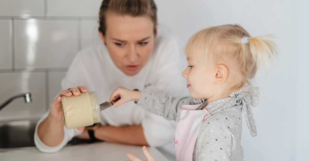 child helping parent in kitchen simple task