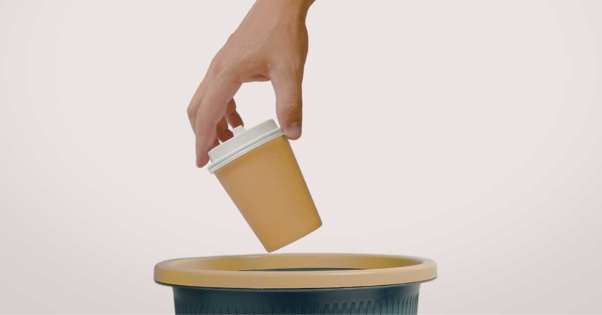 throwing cardboard glass into recycle bin at home