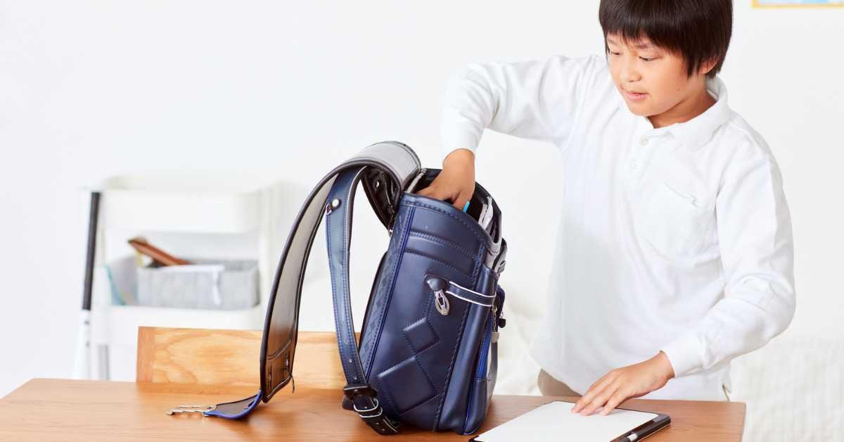 child organizing school bag independently