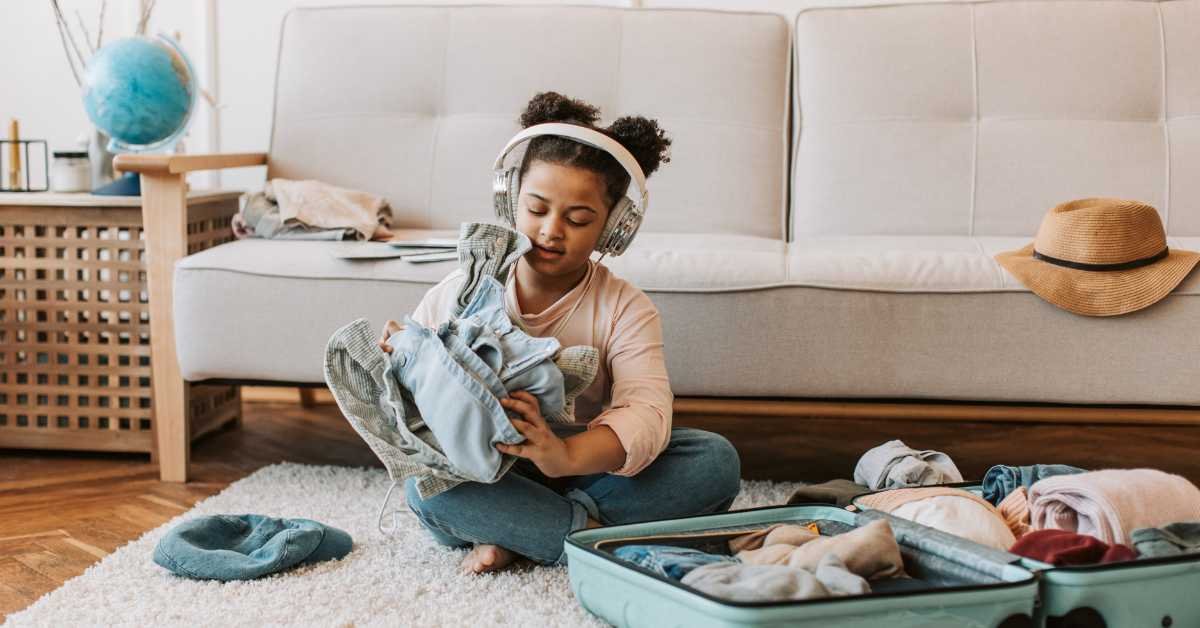 child folding clothes imperfectly learning