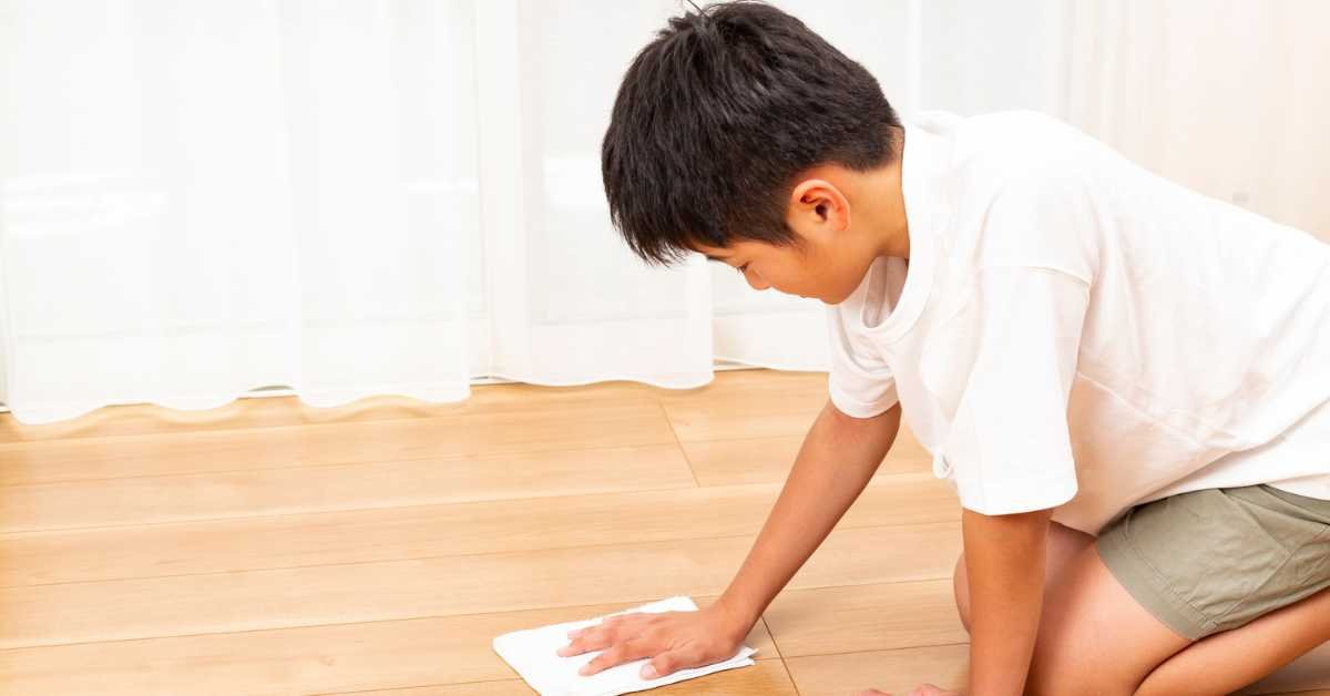 child cleaning floor before resting