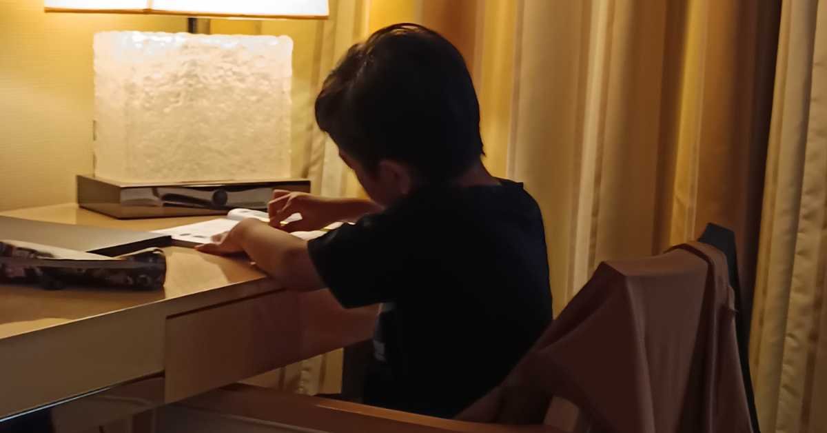 child finishing homework before playing evening routine