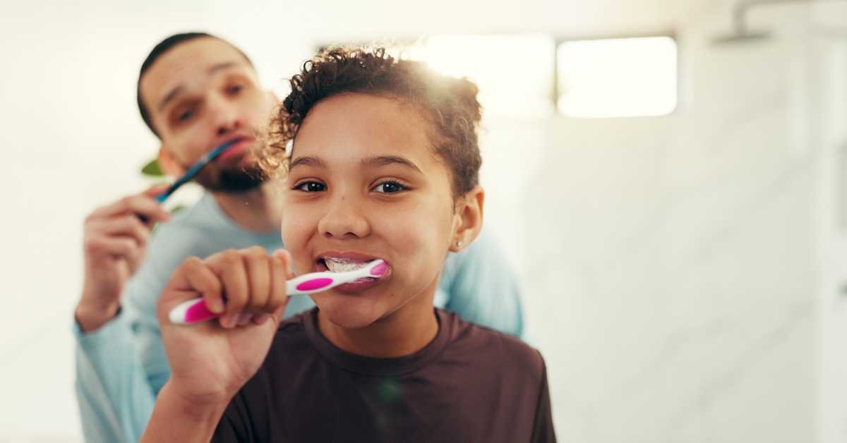 Parent and child cleaning together smiling home